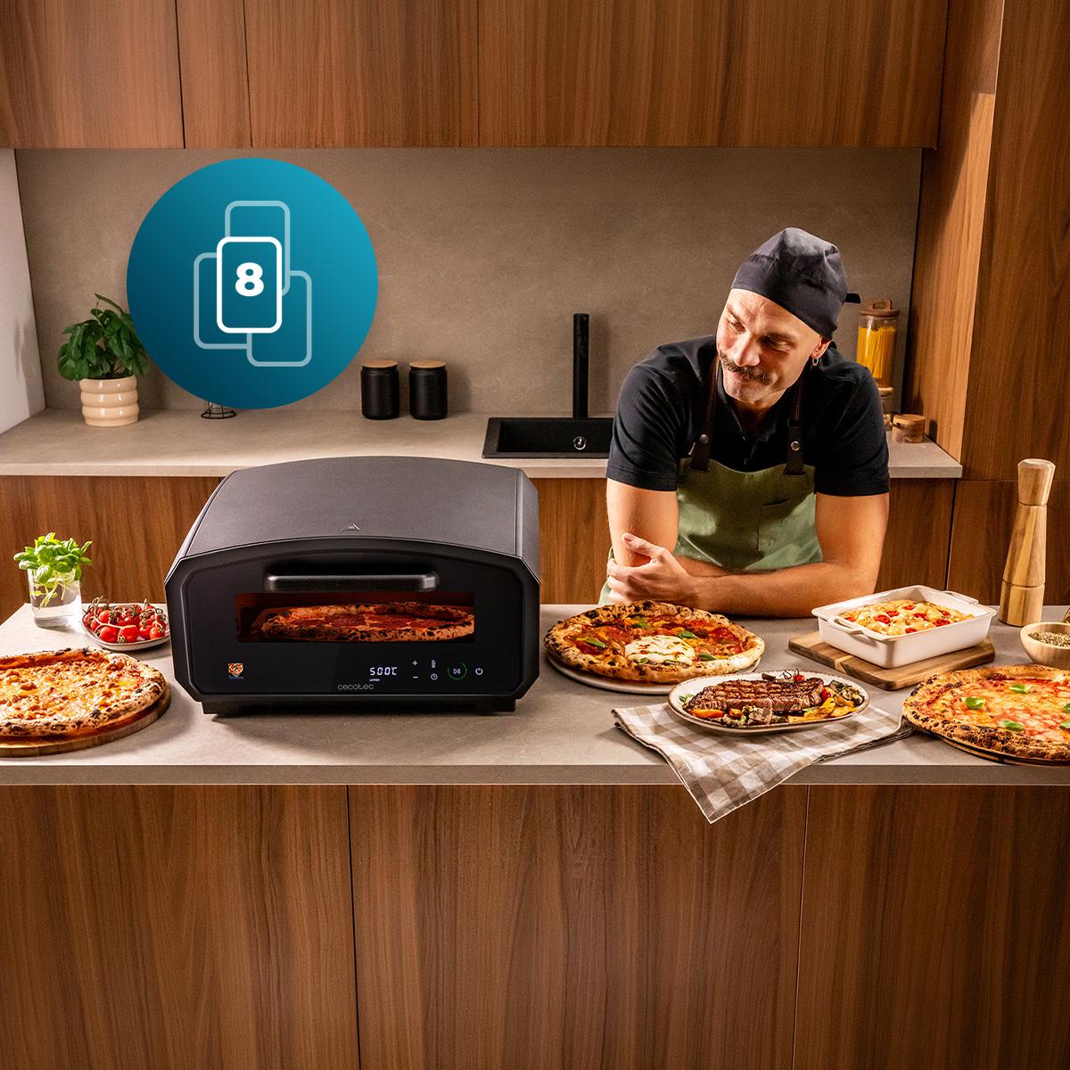 Le Cecotec Pizza&Co 500 Gyro posé sur un plan de travail, entouré de pizzas cuites